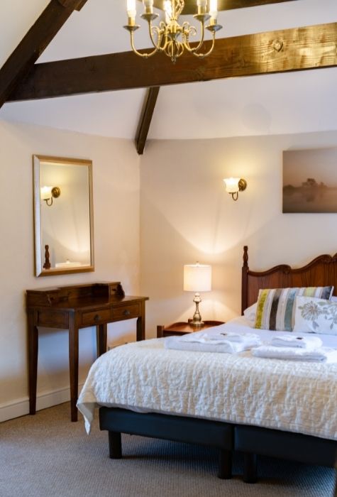The Place To Stay, Knoll Hill Farm, Stylish Boutique Bed and Breakfast Guest House Accommodation For The Perfect Staycation & holiday ~ Room 6 (Willow Tree) En-Suite Deluxe Family Suite Sleeps 2 + 3 In Three Rooms ~ Room size: 51 sqm (20 sqm + 20 sqm + 11 sqm). This Suite Allows You To Indulge Yourselves. Room 6 is a very stylish suite of rooms comprising a main bedroom, a second bedroom, a conservatory and a shower room. The main bedroom is a spacious deluxe king room, which retains many of the original barn features including a beamed ceiling and stoned wall. The room also boasts a splendid free standing roll top bath inviting you to luxuriate and relax whilst engrossed in your current novel. Adjoining the main bedroom is a delightful airy and light conservatory, a spacious and comfortable place to spend the evenings, relaxing after a busy day sight-seeing while looking out over the gardens and the distant hills. The Place To Stay, Knoll Hill Farm, Stylish Boutique Bed and Breakfast Guest House Accommodation For The Perfect Staycation & holiday ~ Room 6 (Willow Tree) En-Suite Deluxe Family Suite Sleeps 2 + 3 In Three Rooms ~ Room size: 51 sqm (20 sqm + 20 sqm + 11 sqm). This Suite Allows You To Indulge Yourselves. Room 6 is a very stylish suite of rooms comprising a main bedroom, a second bedroom, a conservatory and a shower room. The main bedroom is a spacious deluxe king room, which retains many of the original barn features including a beamed ceiling and stoned wall. The room also boasts a splendid free standing roll top bath inviting you to luxuriate and relax whilst engrossed in your current novel. Adjoining the main bedroom is a delightful airy and light conservatory, a spacious and comfortable place to spend the evenings, relaxing after a busy day sight-seeing while looking out over the gardens and the distant hills.