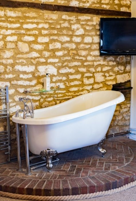 The Place To Stay, Knoll Hill Farm, Stylish Boutique Bed and Breakfast Guest House Accommodation For The Perfect Staycation & holiday ~ Room 6 (Willow Tree) En-Suite Deluxe Family Suite Sleeps 2 + 3 In Three Rooms ~ Room size: 51 sqm (20 sqm + 20 sqm + 11 sqm). This Suite Allows You To Indulge Yourselves. Room 6 is a very stylish suite of rooms comprising a main bedroom, a second bedroom, a conservatory and a shower room. The main bedroom is a spacious deluxe king room, which retains many of the original barn features including a beamed ceiling and stoned wall. The room also boasts a splendid free standing roll top bath inviting you to luxuriate and relax whilst engrossed in your current novel. Adjoining the main bedroom is a delightful airy and light conservatory, a spacious and comfortable place to spend the evenings, relaxing after a busy day sight-seeing while looking out over the gardens and the distant hills. The Place To Stay, Knoll Hill Farm, Stylish Boutique Bed and Breakfast Guest House Accommodation For The Perfect Staycation & holiday ~ Room 6 (Willow Tree) En-Suite Deluxe Family Suite Sleeps 2 + 3 In Three Rooms ~ Room size: 51 sqm (20 sqm + 20 sqm + 11 sqm). This Suite Allows You To Indulge Yourselves. Room 6 is a very stylish suite of rooms comprising a main bedroom, a second bedroom, a conservatory and a shower room. The main bedroom is a spacious deluxe king room, which retains many of the original barn features including a beamed ceiling and stoned wall. The room also boasts a splendid free standing roll top bath inviting you to luxuriate and relax whilst engrossed in your current novel. Adjoining the main bedroom is a delightful airy and light conservatory, a spacious and comfortable place to spend the evenings, relaxing after a busy day sight-seeing while looking out over the gardens and the distant hills.